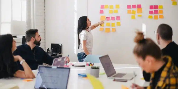 woman placing sticky notes on wall